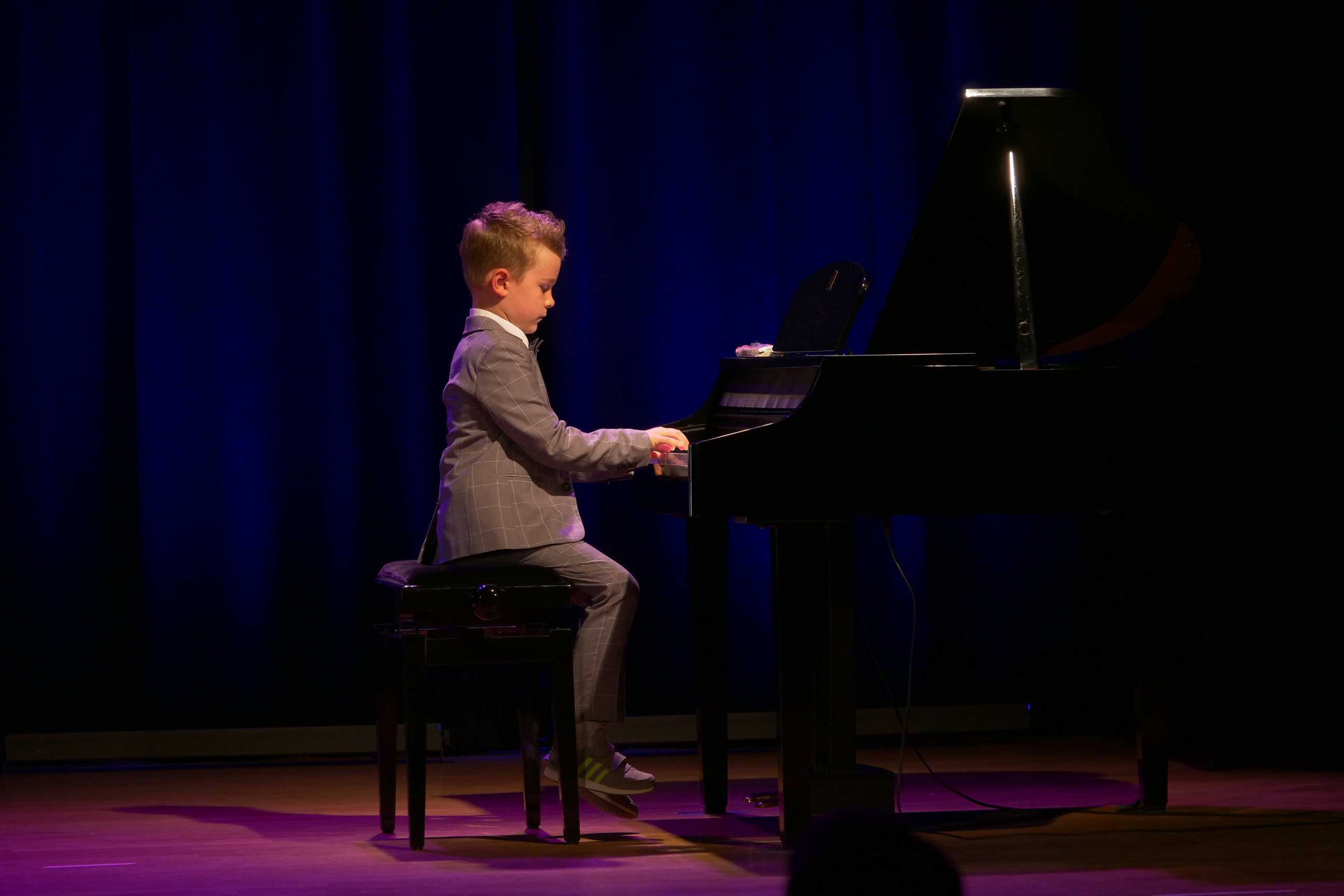 Pianista na scenie podczas popisów muzyczne dzieci i młodzieży w Miejskim Ośrodku Kultury w Wojkowicach