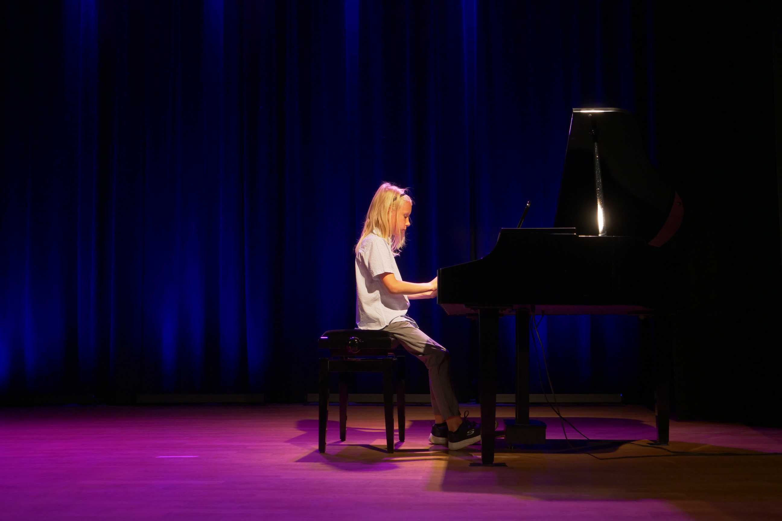 Pianista na scenie podczas popisów muzyczne dzieci i młodzieży w Miejskim Ośrodku Kultury w Wojkowicach